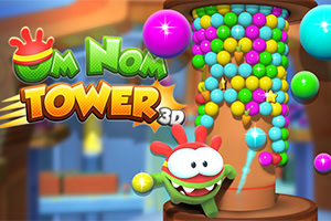 Simpatični zeleni lik pored tornja od šarenih loptica u igri Om Nom Tower 3D